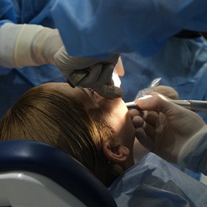 Woman getting dental surgery