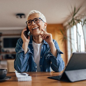 Woman smiling while talking on phone at home