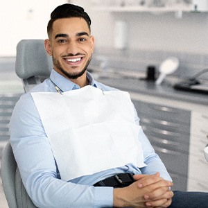 Patient smiling while sitting in treatment chair