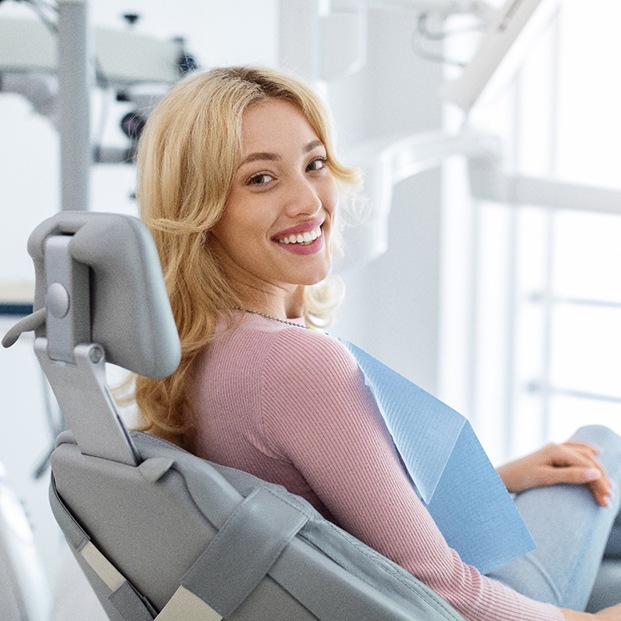 Woman smiling while sitting in treatment chair